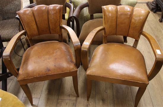 A pair of vintage leather elbow chairs